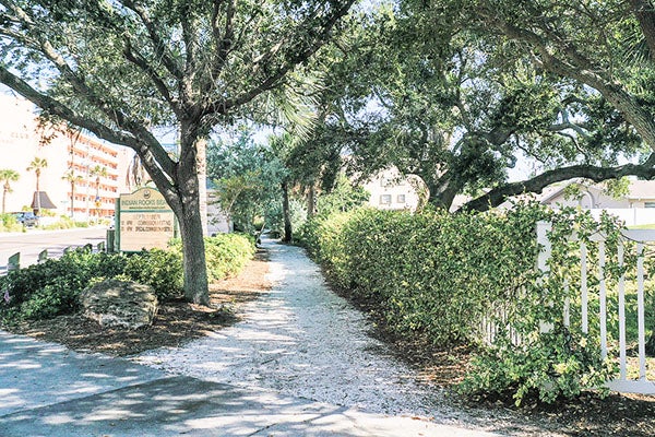 nature preserve entrance with sign within city