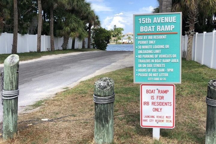 15th avenue Boat ramp sign says use by IRB resident permit only 30 minute loading or unloading limit no parking or vehicles or trailers in boat ramp area or on side streets hours of use are 8am to 9pm please do not liter